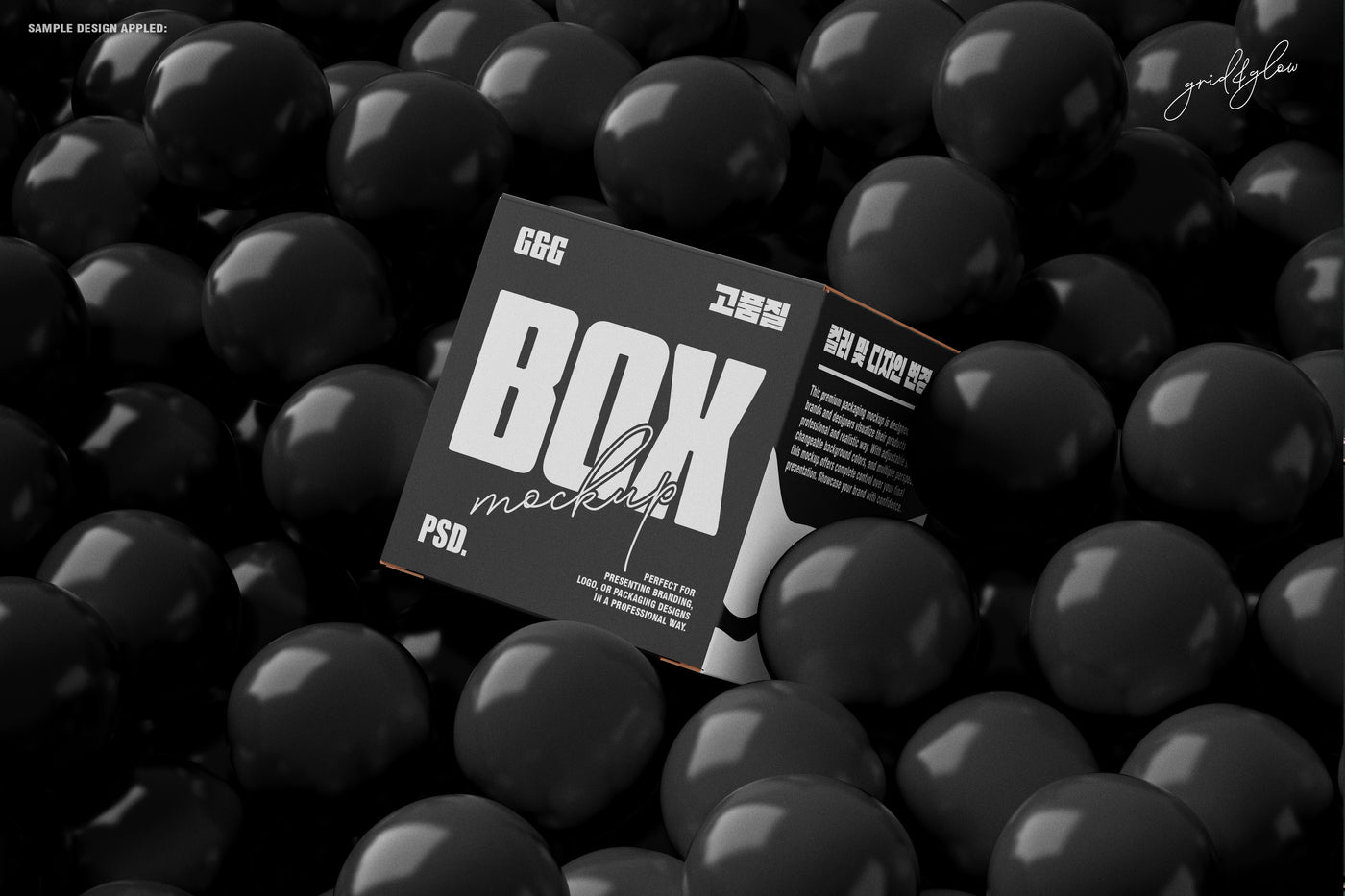 Black square box mockup resting in a pool of glossy black balls