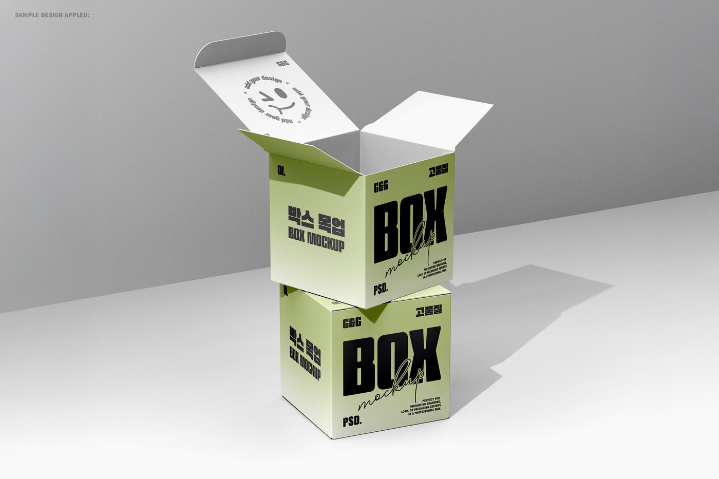 Vertical stacked square boxes, top one open showing interior print and shadow play in minimal lighting.