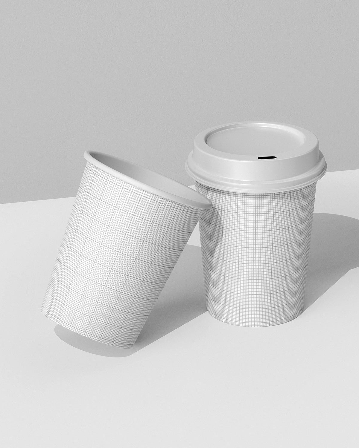 Two coffee cup mockups in leaning arrangement showing customizable branding design grid scene