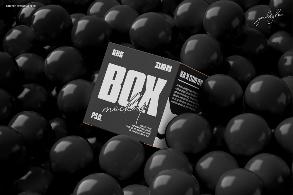 Black square box mockup resting in a pool of glossy black balls