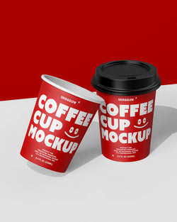 Two coffee cup mockups in leaning arrangement showing customizable branding design red scene