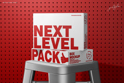 Two cardboard boxes with 'Next Level Pack' text on a red pegboard background