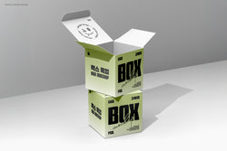 Vertical stacked square boxes, top one open showing interior print and shadow play in minimal lighting.