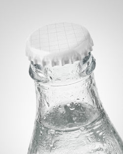 Glass bottle mockup with grid crown cap and clear water with condensation droplets