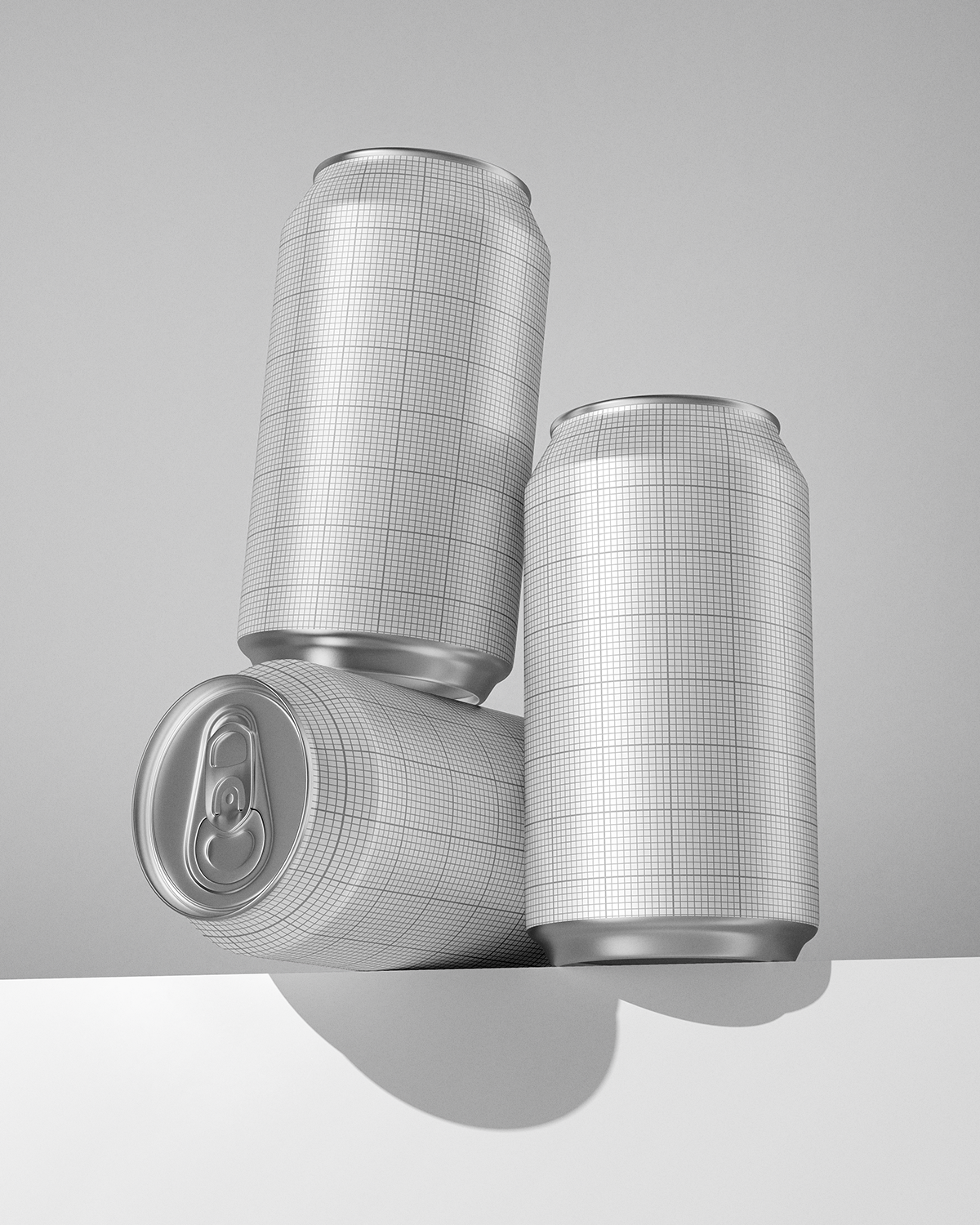 Three silver cans stacked on a light gray background