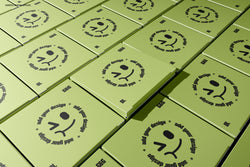 Patterned flat layout of square box mockups with top designs facing upward in a seamless presentation.