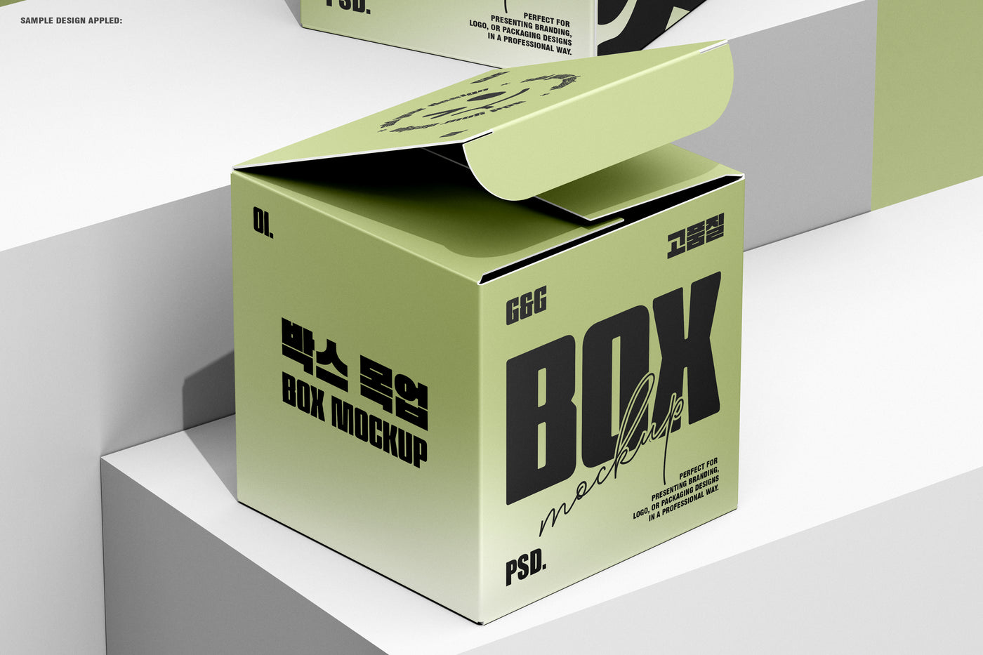 Opened green square box mockup placed on white step blocks with a second closed box in the background.