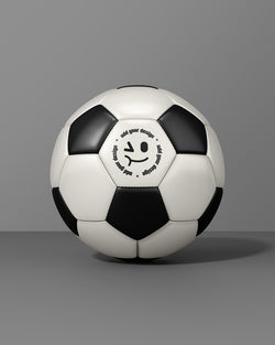 Soccer ball mockup with black and white panels in front view on gray background