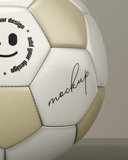 Soccer ball mockup with gold and white panels in front view on beige background macro